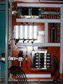 controls enclosure interior showing the PLC controller, pneumatic valves, and redundant 24vdc power supplies